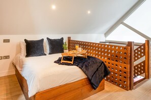 Mezzanine Master Bedroom with double bed overlooking the dining area.