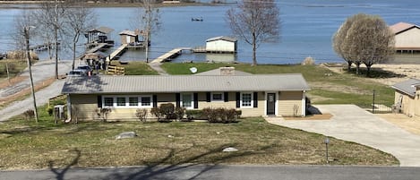 View of front of the house from across the street.  Large concrete driveway.