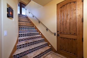 This stunning staircase brings you upstairs, tiles inspired by Hearst Castle