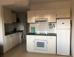 New oven, electric hob, large fridge with freezer. There is a microwave 