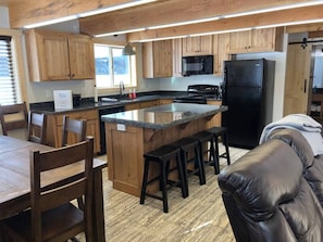 Full Kitchen equipped with basic cooking supplies