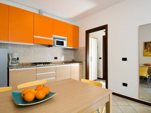 Room, Yellow, Orange, Furniture, Kitchen, Countertop, Property, Interior Design, Cabinetry, Floor