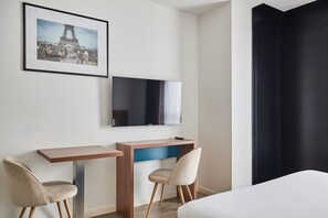 The contemporary furnishings and vibrant color accents create an appealing atmosphere in this comfortable space tailored for short or extended stays.