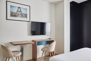 The contemporary furnishings and vibrant color accents create an appealing atmosphere in this comfortable space tailored for short or extended stays.