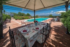 The shaded terrace is the perfect spot to enjoy lunch by the pool