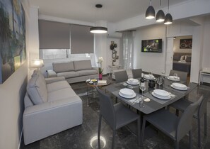 The spacious, sunny living room with the open plan kitchen