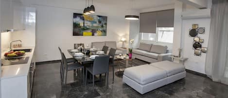 The spacious, sunny living room with the open plan kitchen