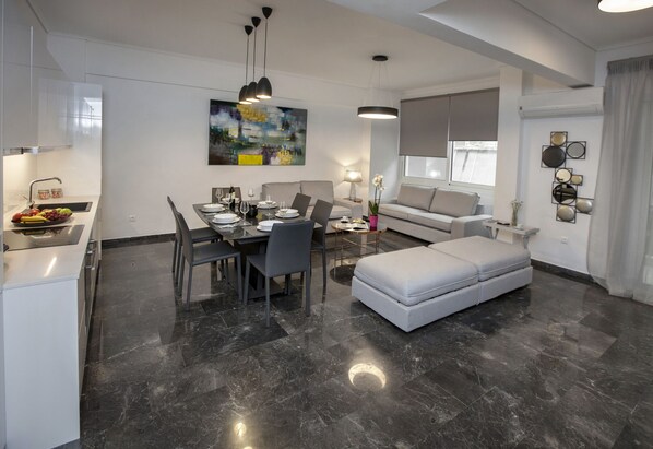 The spacious, sunny living room with the open plan kitchen