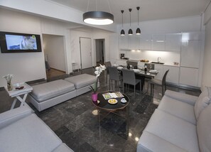 The spacious, sunny living room with the open plan kitchen