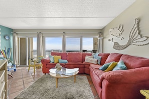 Family Room with a View - Enjoy sitting on the couch and playing a game of cards or watching the waves crash on the beach.	