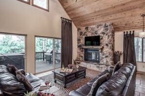 Living Room with Tv, Fireplace and Entrance to Back Deck