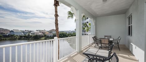 Visit the beautiful balcony for a breath of fresh Florida air. - The beautiful balcony of 1033 Cinnamon Beach, complete with palm tree and lagoon views, is an all-time favorite!