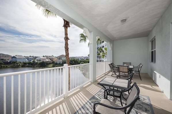 Visit the beautiful balcony for a breath of fresh Florida air. - The beautiful balcony of 1033 Cinnamon Beach, complete with palm tree and lagoon views, is an all-time favorite!