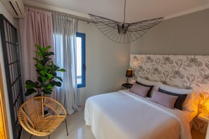 Bedroom with double bed, air conditioning and ensuite bathroom.