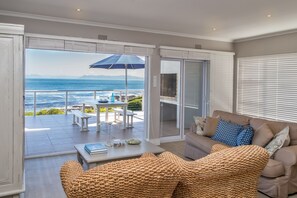 Living room onto extended deck with outdoor braai facility