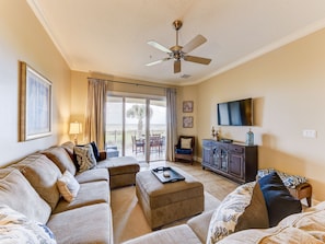 Bright and Airy - living room is perfectly open and welcoming! The plush sofa is so ideal for sinking into and watching a movie with the family with the huge HDTV!