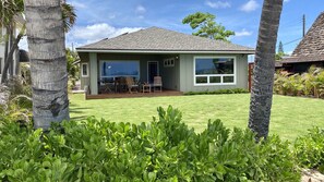 Photo taken from the beach.  Large covered deck with dining table and BBQ grill.