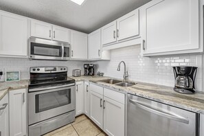 Full Kitchen with Granite Countertops, Stainless Steel Appliances and additional Seating at the Breakfast Bar