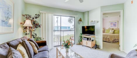 Our living room has classic Florida style! - With bold tropical prints and bamboo structure, our comfy living room with bright balcony doors is a welcome site that you'll love coming home to every night.