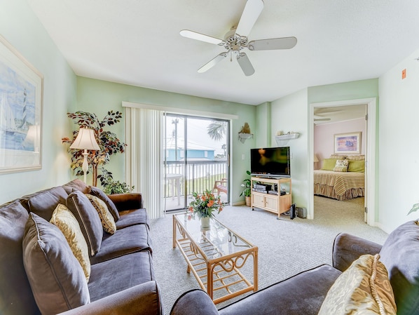 Our living room has classic Florida style! - With bold tropical prints and bamboo structure, our comfy living room with bright balcony doors is a welcome site that you'll love coming home to every night.