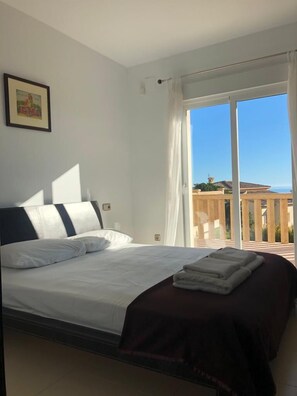 Double bedroom overlooking terrace and pool