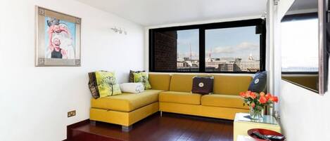 Bright and modern, the open-plan living space has tremendous views. The sofa doubles as a King-sized bed.