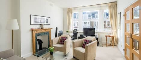 The living room is bright & airy, flooded with natural daylight.