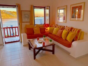 living room with balcony and sea view