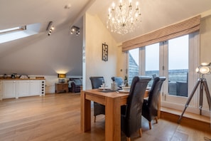 9 Fernhill Penthouse, Carbis Bay. Dining area: Table seating four guests with patio doors to balcony