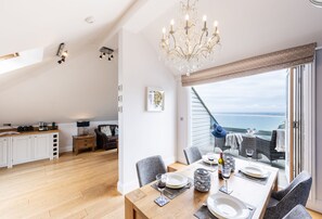 9 Fernhill Penthouse, Carbis Bay. Ocean vistas can be enjoyed from the dining table or out on the lovely balcony.