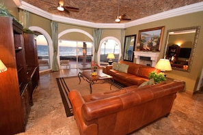 Looking out onto the beach from the living room. 65" flat screen & Fireplace