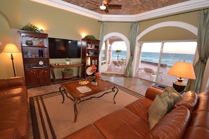 A different angle of the grand room with domed brick ceiling and a large 65" TV