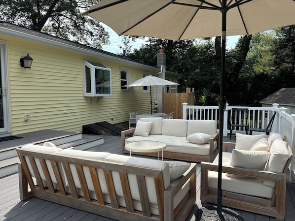 3 tiered deck with couches, table, grill and cedar outdoor shower