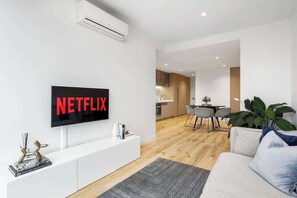 Open-planned living room with flat-screen TV 