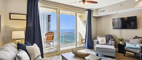 Living room with sleeper sofa and entrance onto the balcony.