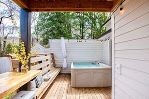 Spa deck with spa towels, privacy curtain, personal bar and seating, dry sauna, and 5 person hot tub.