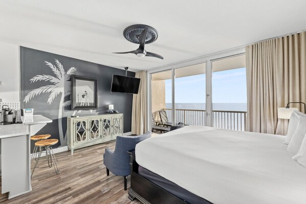 Cozy studio with a comfortable bed, kitchenette, and private balcony overlooking the Gulf of Mexico