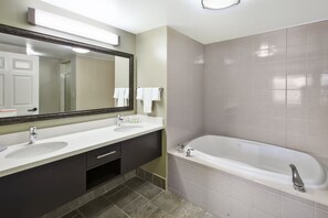 Get ready for your day in the bathroom that features a jacuzzi.