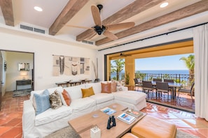 Floor to ceiling glass doors open to create indoor/outdoor living space