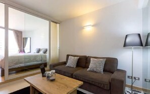 Sofa bed by Ikea. Practical coffee table, light can move around easily