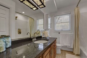 Master Bathroom with Tub/Shower Combo and Sink. Clothes Washer and Dryer are in the Bathroom Closet.