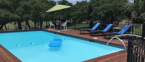 Large 16x32 swimming pool with seating in the sun and shade.