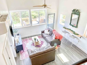 Living room with two couches and a SmartTV with complimentary Youtube TV 