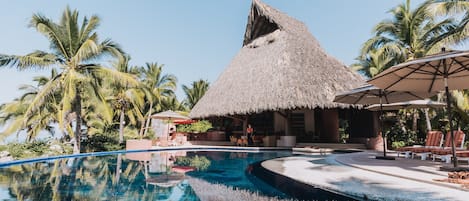 Swimming pool and the largest palapa on the beach.