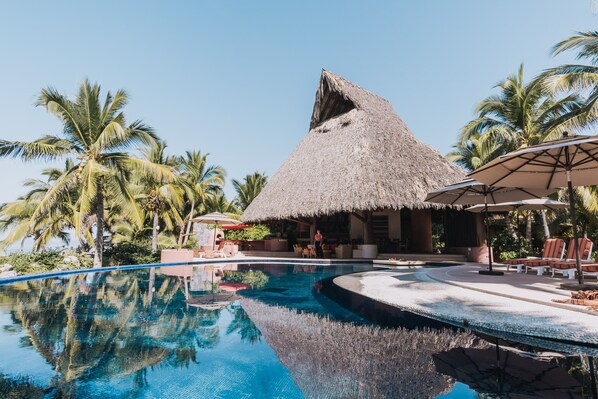 Swimming pool and the largest palapa on the beach.