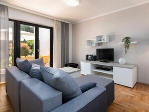 Furniture, Couch, Property, Comfort, Interior Design, Lighting, Living Room, Floor, Plant, Shade