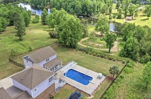 Aerial Rear. Completely fenced in backyard. Large pond for fishing. 