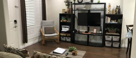 Living room with 43” TV, view from Murphy bed area when it is tucked away