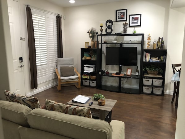 Living room with 43” TV, view from Murphy bed area when it is tucked away