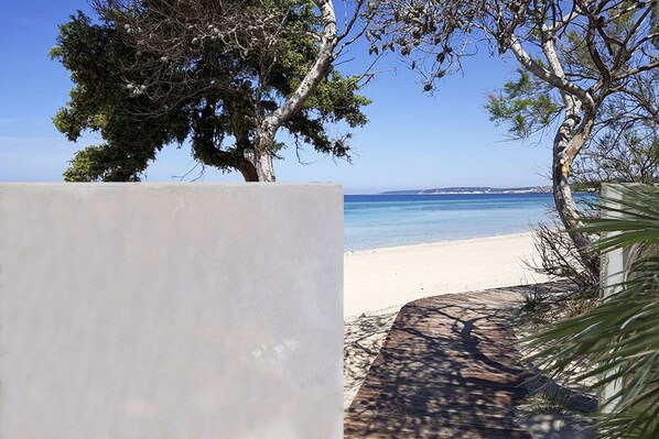 The private access to the beach through the property back courtyard's gate